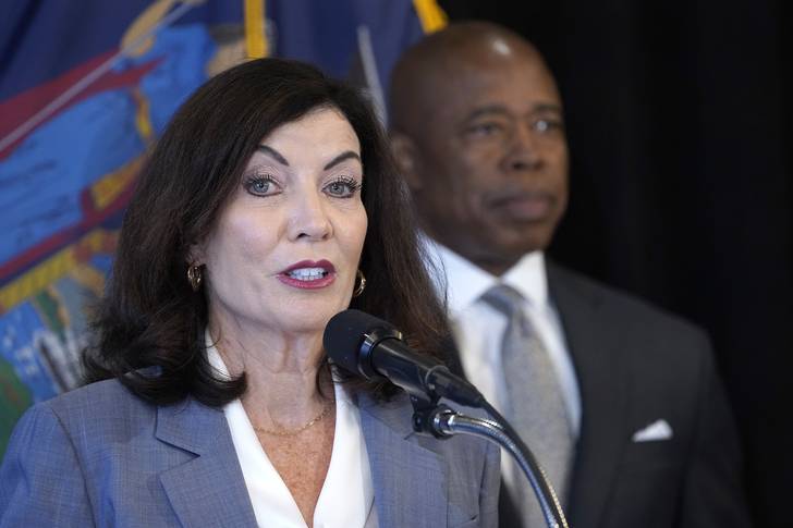 Gov. Kathy Hochul at a news conference addressing plans to reduce gun violence. Hochul offered lukewarm support for a bill to reduce class sizes, which Mayor Eric Adams (background) strongly opposes.